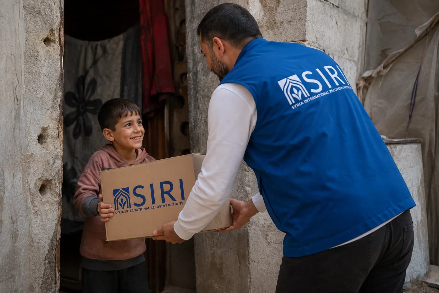 A SIRI team member handing a delivery box to a smiling boy